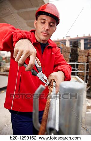 Worker using pliers in construction site, preparing concrete rods View Large Photo Image Stock Image - Worker using pliers in construction site, preparing concrete rods. Fotosearch