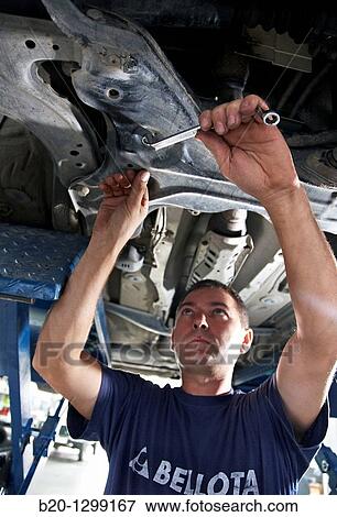 Worker using ring spanner in car repair shop View Large Photo Image Stock Photo - Worker using ring spanner in car repair shop. Fotosearch