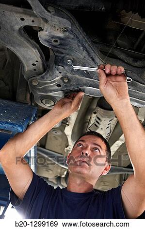 Worker using ring spanner in car repair shop View Large Photo Image Stock Photo - Worker using ring spanner in car repair shop. Fotosearch