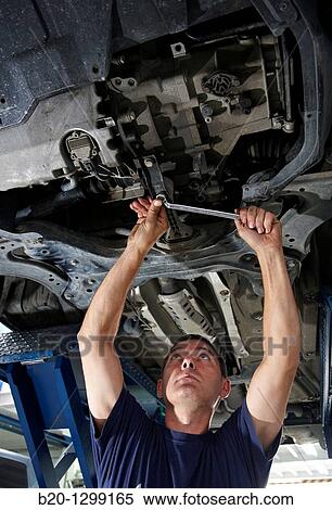 Worker using ring spanner in car repair shop View Large Photo Image Stock Photography - Worker using ring spanner in car repair shop. Fotosearch