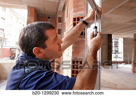 Worker using screwdriver, assembling window frame, new homes under construction, construction site View Large Photo Image Stock Image - Worker using screwdriver, assembling window frame, new homes under construction, construction site. Fotosearch