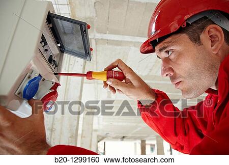 Worker using screwdriver in construction site, fuse box View Large Photo Image Stock Image - Worker using screwdriver in construction site, fuse box. Fotosearch