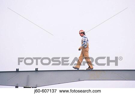 Worker walking on beam View Large Photo Image Stock Photo - Worker walking on beam. Fotosearch