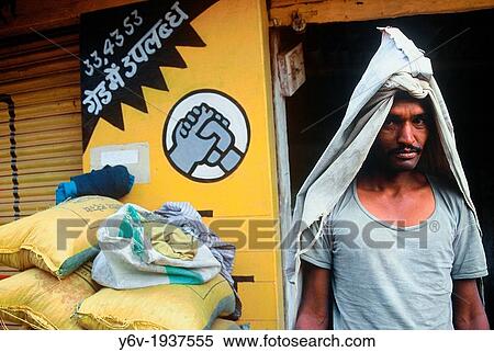 Worker whose work is to load and download sacks of cement near the logo of the company for which he is working. India. View Large Photo Image Stock Photography - Worker whose work is to load and download sacks of cement near the logo of the company for which he is working. India.. Fotosearch