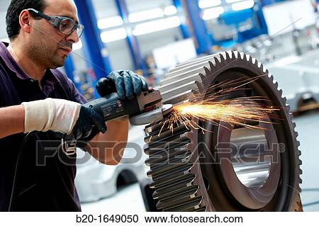 Worker with grinder finish by piece, production of steel gears, cogwheel, mechanical industry, gearbox mill, Gipuzkoa, Basque Country, Spain View Large Photo Image Stock Image - Worker with grinder finish by piece, production of steel gears, cogwheel, mechanical industry, gearbox mill, Gipuzkoa, Basque Country, Spain. Fotosearch