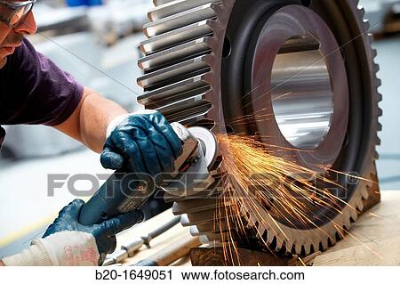 Worker with grinder finish by piece, production of steel gears, cogwheel, mechanical industry, gearbox mill, Gipuzkoa, Basque Country, Spain View Large Photo Image Stock Image - Worker with grinder finish by piece, production of steel gears, cogwheel, mechanical industry, gearbox mill, Gipuzkoa, Basque Country, Spain. Fotosearch