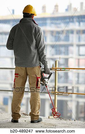 Worker with mass mixer. Housing construction, apartments. San Sebastian, Gipuzkoa, Euskadi. Spain. View Large Photo Image Stock Photo - Worker with mass mixer. Housing construction, apartments. San Sebastian, Gipuzkoa, Euskadi. Spain.. Fotosearch