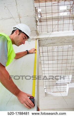 Worker with protective equipment, PPE, Taking measures in concrete beam, retractable tape, housing construction, Basque Country, Spain View Large Photo Image Stock Image - Worker with protective equipment, PPE, Taking measures in concrete beam, retractable tape, housing construction, Basque Country, Spain. Fotosearch