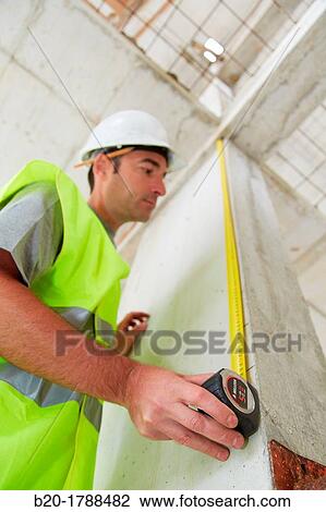 Worker with protective equipment, PPE, Taking measures in concrete beam, retractable tape, housing construction, Basque Country, Spain View Large Photo Image Stock Image - Worker with protective equipment, PPE, Taking measures in concrete beam, retractable tape, housing construction, Basque Country, Spain. Fotosearch