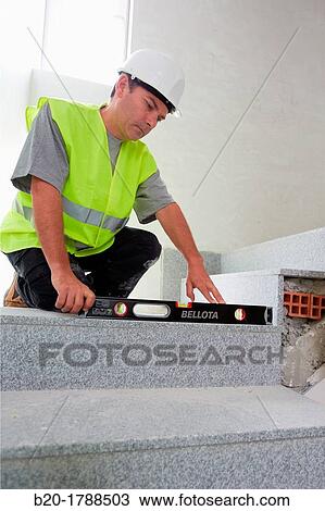 Worker with protective equipment, PPE, Leveling ladder rung, housing construction, level, Basque Country, Spain View Large Photo Image Stock Image - Worker with protective equipment, PPE, Leveling ladder rung, housing construction, level, Basque Country, Spain. Fotosearch