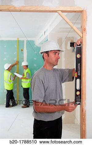 Worker with protective equipment, PPE, Leveling reframe door, housing construction, level, Basque Country, Spain View Large Photo Image Stock Image - Worker with protective equipment, PPE, Leveling reframe door, housing construction, level, Basque Country, Spain. Fotosearch