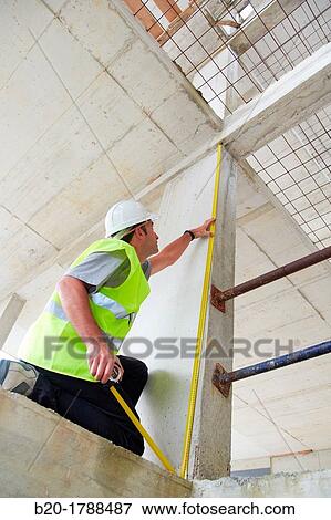 Worker with protective equipment, PPE, Taking measures in concrete beam, retractable tape, housing construction, Basque Country, Spain View Large Photo Image Stock Photo - Worker with protective equipment, PPE, Taking measures in concrete beam, retractable tape, housing construction, Basque Country, Spain. Fotosearch