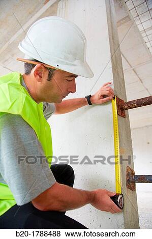 Worker with protective equipment, PPE, Taking measures in concrete beam, retractable tape, housing construction, Basque Country, Spain View Large Photo Image Stock Photo - Worker with protective equipment, PPE, Taking measures in concrete beam, retractable tape, housing construction, Basque Country, Spain. Fotosearch