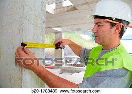 Worker with protective equipment, PPE, Taking measures in concrete beam, retractable tape, housing construction, Basque Country, Spain View Large Photo Image Stock Photo - Worker with protective equipment, PPE, Taking measures in concrete beam, retractable tape, housing construction, Basque Country, Spain. Fotosearch