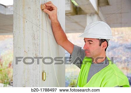 Worker with protective equipment, PPE, Checking and aligning vertical sections in concrete walls, housing construction, Plumb line, Basque Country, Spain View Large Photo Image Stock Photo - Worker with protective equipment, PPE, Checking and aligning vertical sections in concrete walls, housing construction, Plumb line, Basque Country, Spain. Fotosearch