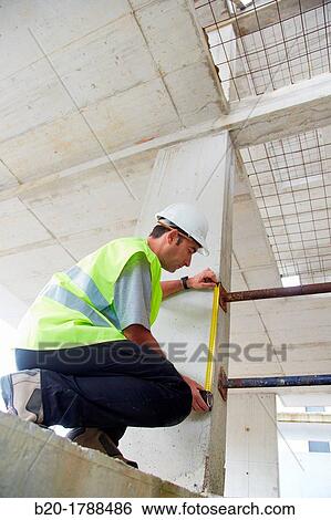 Worker with protective equipment, PPE, Taking measures in concrete beam, retractable tape, housing construction, Basque Country, Spain View Large Photo Image Stock Photograph - Worker with protective equipment, PPE, Taking measures in concrete beam, retractable tape, housing construction, Basque Country, Spain. Fotosearch