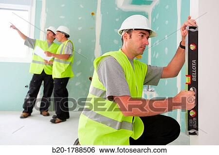 Worker with protective equipment, PPE, Leveling plasterboard panels, housing construction, level, Basque Country, Spain View Large Photo Image Stock Photograph - Worker with protective equipment, PPE, Leveling plasterboard panels, housing construction, level, Basque Country, Spain. Fotosearch