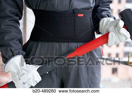 Stock Image - Worker with tools and safety equipment.. Fotosearch