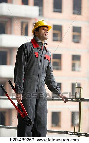 Worker with working clothes and pliers. Housing construction, apartments. San Sebastian, Gipuzkoa, Euskadi. Spain. View Large Photo Image Stock Photo - Worker with working clothes and pliers. Housing construction, apartments. San Sebastian, Gipuzkoa, Euskadi. Spain.. Fotosearch