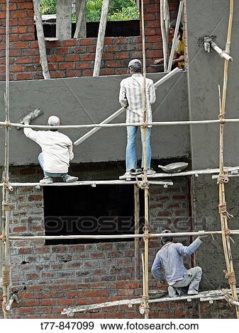 Stock Photo - Workers are working on construction of a building Pune, Maharashtra, India. Fotosearch