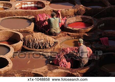 Stock Photo - Workers at the Chouwara Tannery, Fez, Morocco, North Africa. Fotosearch
