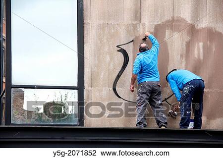 Workers cleaning graffiti on shop wall in Rome Italy View Large Photo Image Stock Image - Workers cleaning graffiti on shop wall in Rome Italy. Fotosearch