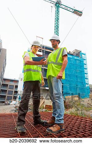 Workers consulting a tablet. Homebuilding. Construction work. Donostia. San Sebastian. Gipuzkoa. Basque Country. Spain View Large Photo Image Stock Image - Workers consulting a tablet. Homebuilding. Construction work. Donostia. San Sebastian. Gipuzkoa. Basque Country. Spain. Fotosearch