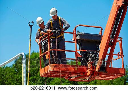 Workers in basket lift. View Large Photo Image Stock Image - Workers in basket lift.. Fotosearch