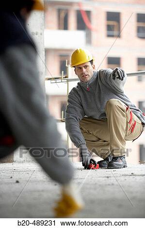 Workers marking and measuring. Housing construction, apartments. San Sebastian, Gipuzkoa, Euskadi. Spain. View Large Photo Image Stock Image - Workers marking and measuring. Housing construction, apartments. San Sebastian, Gipuzkoa, Euskadi. Spain.. Fotosearch