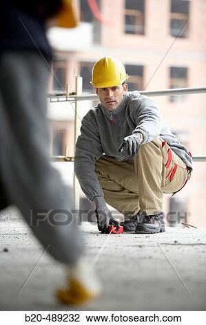 Workers marking and measuring. Housing construction, apartments. San Sebastian, Gipuzkoa, Euskadi. Spain. View Large Photo Image Stock Image - Workers marking and measuring. Housing construction, apartments. San Sebastian, Gipuzkoa, Euskadi. Spain.. Fotosearch