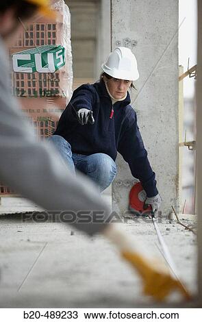 Workers measuring with measuring tape. Housing construction, apartments. San Sebastian, Gipuzkoa, Euskadi. Spain. View Large Photo Image Stock Image - Workers measuring with measuring tape. Housing construction, apartments. San Sebastian, Gipuzkoa, Euskadi. Spain.. Fotosearch