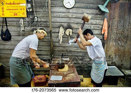 workers pounding peanut brittle at the Vegetarian Festival in Bangkok, Thailand. View Large Photo Image Stock Photography - workers pounding peanut brittle at the Vegetarian Festival in Bangkok, Thailand.. Fotosearch