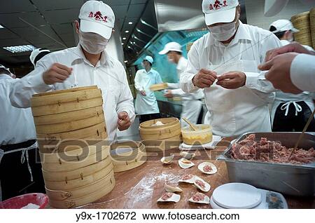 Workers preparing handmade dumplings in the kitchen of the world renowned Din Tai Fung Restaurant, located in Taipei, Taiwan. View Large Photo Image Stock Image - Workers preparing handmade dumplings in the kitchen of the world renowned Din Tai Fung Restaurant, located in Taipei, Taiwan.. Fotosearch