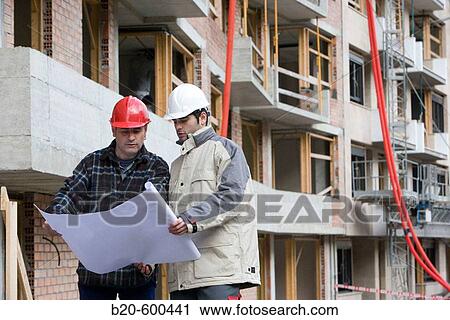 Workers with blueprints. Building construction. View Large Photo Image Stock Image - Workers with blueprints. Building construction.. Fotosearch