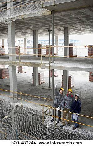 Workers with blueprints. Housing construction, apartments. San Sebastian, Gipuzkoa, Euskadi. Spain. View Large Photo Image Picture - Workers with blueprints. Housing construction, apartments. San Sebastian, Gipuzkoa, Euskadi. Spain.. Fotosearch