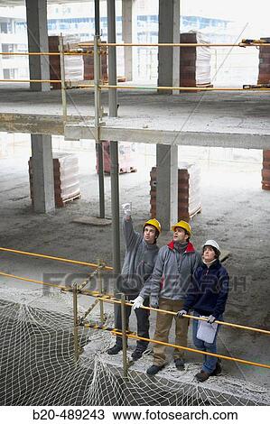 Workers with blueprints. Housing construction, apartments. San Sebastian, Gipuzkoa, Euskadi. Spain. View Large Photo Image Stock Image - Workers with blueprints. Housing construction, apartments. San Sebastian, Gipuzkoa, Euskadi. Spain.. Fotosearch