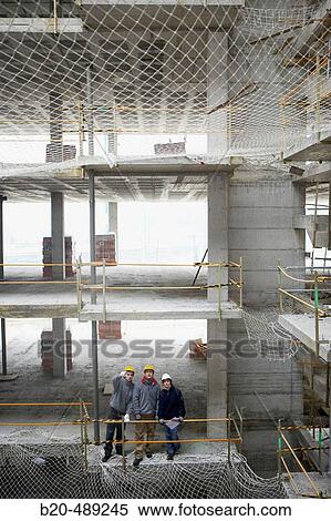 Stock Photography - Workers with blueprints. Housing construction, apartments. San Sebastian, Gipuzkoa, Euskadi. Spain.. Fotosearch