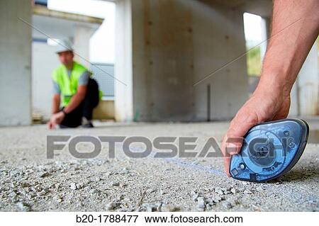 Workers with personal protective equipment, PPE, Marking guide lines for the construction of interior walls, Line tracer, housing construction, concrete, Basque Country, Spain View Large Photo Image Stock Photo - Workers with personal protective equipment, PPE, Marking guide lines for the construction of interior walls, Line tracer, housing construction, concrete, Basque Country, Spain. Fotosearch