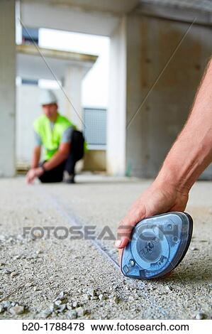 Workers with personal protective equipment, PPE, Marking guide lines for the construction of interior walls, Line tracer, housing construction, concrete, Basque Country, Spain View Large Photo Image Stock Photo - Workers with personal protective equipment, PPE, Marking guide lines for the construction of interior walls, Line tracer, housing construction, concrete, Basque Country, Spain. Fotosearch