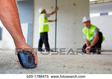 Workers with personal protective equipment, PPE, Marking guide lines for the construction of interior walls, Line tracer, housing construction, concrete, Basque Country, Spain View Large Photo Image Stock Photography - Workers with personal protective equipment, PPE, Marking guide lines for the construction of interior walls, Line tracer, housing construction, concrete, Basque Country, Spain. Fotosearch