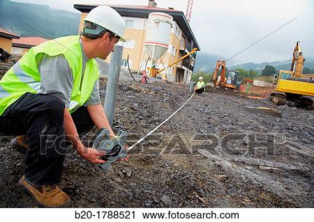 Workers with protective equipment, PPE, Taking measures in urbanization, Outside, Housing construction, Measuring tape, Basque Country, Spain View Large Photo Image Stock Image - Workers with protective equipment, PPE, Taking measures in urbanization, Outside, Housing construction, Measuring tape, Basque Country, Spain. Fotosearch