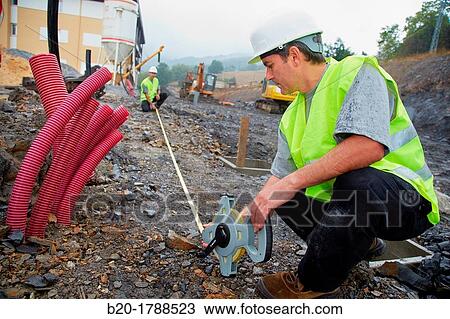 Workers with protective equipment, PPE, Taking measures in urbanization, Outside, Housing construction, Measuring tape, Basque Country, Spain View Large Photo Image Stock Image - Workers with protective equipment, PPE, Taking measures in urbanization, Outside, Housing construction, Measuring tape, Basque Country, Spain. Fotosearch