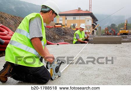 Workers with protective equipment, PPE, Taking measures in urbanization, Outside, Housing construction, Measuring tape, Basque Country, Spain View Large Photo Image Stock Photo - Workers with protective equipment, PPE, Taking measures in urbanization, Outside, Housing construction, Measuring tape, Basque Country, Spain. Fotosearch