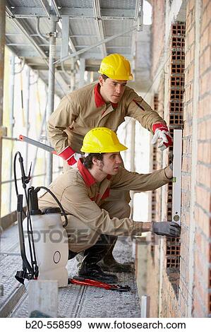 Workers with spirit level on scaffold, housing construction. Guipuzcoa, Euskadi, Spain View Large Photo Image Stock Photo - Workers with spirit level on scaffold, housing construction. Guipuzcoa, Euskadi, Spain. Fotosearch