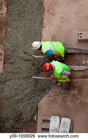 Stock Photograph - Workers working in street, Barcelona, Spain. Fotosearch