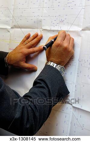Working on blueprints View Large Photo Image Stock Photography - Working on blueprints. Fotosearch