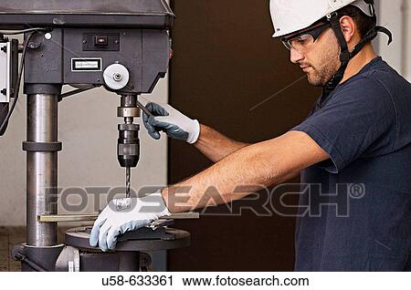 Stock Image - Working with drill.. Fotosearch