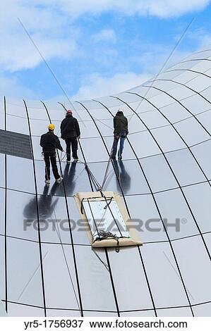 Stock Photo - Workmen on roof of The Sage concert hall in Gateshead, Tyne & Wear, England, United Kingdom. Fotosearch