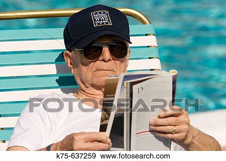 World War II veteran reading magazine, poolside, age 88 View Large Photo Image Stock Photo - World War II veteran reading magazine, poolside, age 88. Fotosearch