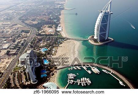 Worlds only 7 star hotel in Dubai UAE called the Burj Al Arab from helicopter above aerial with luxury and water at beach in United Arab Emirates. View Large Photo Image Stock Photography - Worlds only 7 star hotel in Dubai UAE called the Burj Al Arab from helicopter above aerial with luxury and water at beach in United Arab Emirates.. Fotosearch